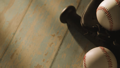 Close-Up-Studio-Baseball-Still-Life-With-Bat-Ball-And-Catchers-Mitt-On-Aged-Wooden-Floor-2